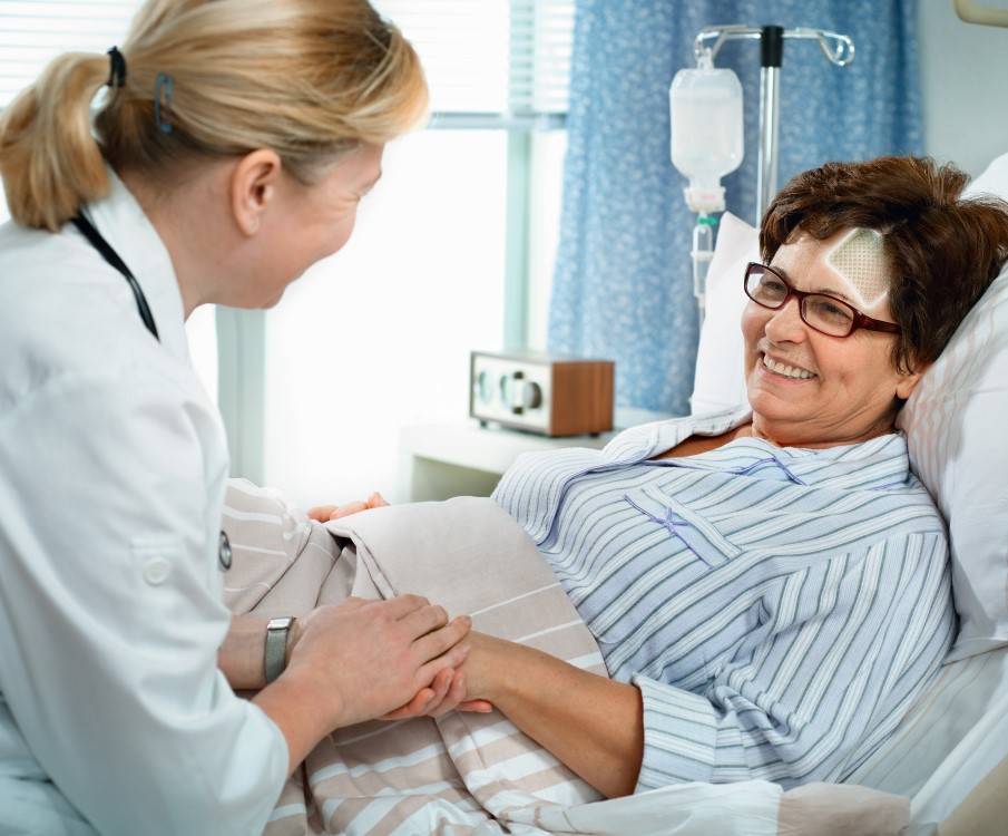 woman in hospitalbed got woundcare from nurse