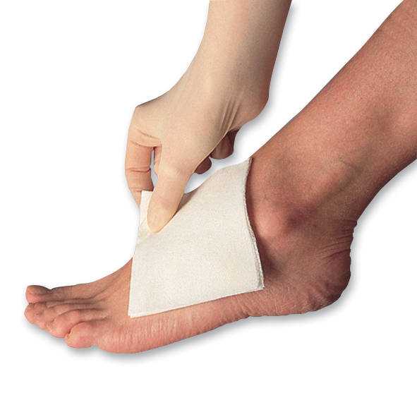 Hand putting gauze on foot