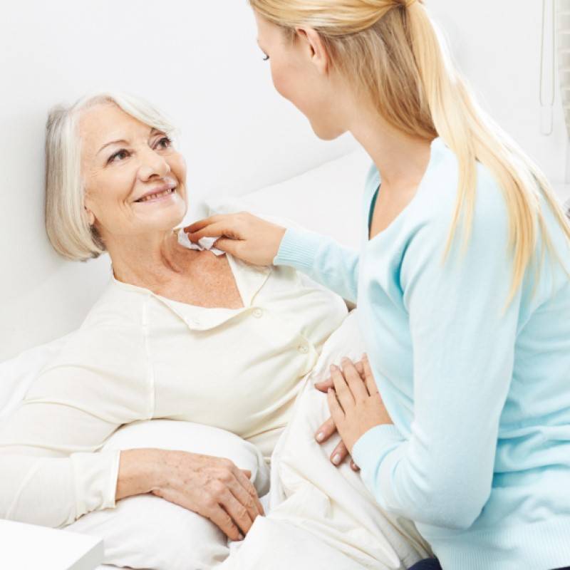 Person in bed being washed